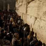 
              Worshippers pray in the women's section of the Western Wall, the holiest site where Jews can pray, in the shadow of the Mughrabi Bridge, a wooden pedestrian bridge connecting the wall to the Al Aqsa Mosque compound, in Jerusalem's Old City, Tuesday, July 20, 2021. The rickety bridge allowing access to Jerusalem's most sensitive holy site is at risk of collapse, according to experts. But the flashpoint shrine's delicate position at ground-zero of the Israeli-Palestinian conflict has prevented its repair for more than a decade. (AP Photo/Maya Alleruzzo)
            