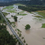 
              In this photo taken with a drone, meadows to the left and right of a road are flooded, near the village of Rettenberg, Germany, Monday July 26, 2021.  Thunderstorms with heavy downpours have caused flooding in the southern Bavaria region early Monday, with emergency services called out to attend inundated homes. (Davor Knappmeyer/dpa via AP)
            