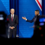 
              Cameras are visible in the foreground as President Joe Biden accompanied by CNN journalist Don Lemon, right, appears at a CNN town hall at Mount St. Joseph University in Cincinnati, Wednesday, July 21, 2021. (AP Photo/Andrew Harnik)
            