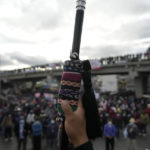 
              An Indigenous person holds up the "leader baton" during a protest on the Inter American Highway in Totonicapan, Guatemala, after Indigenous leaders here called for a nationwide strike to pressure Guatemalan President Alejandro Giammattei to resign, Thursday, July 29, 2021. The protest comes in response to the firing of Special Prosecutor Against Impunity Juan Francisco Sandoval by Attorney General Consuelo Porras. (AP Photo/Moises Castillo)
            