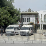 
              FILE - In this July 27, 2021 file photo, police cars and a military armored personnel carrier block a side entrance of the Tunisian parliament in Tunis. Days of political turmoil in Tunisia over the economy and the coronavirus have left its allies in the Middle East, Europe and the United States watching to see if the fragile democracy will survive. (AP Photo/Hassene Dridi, File)
            