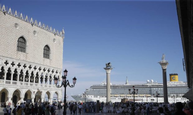 FILE- In this June 2, 2019 file photo, a cruise ship passes by St. Mark's Square in Venice, Italy. ...