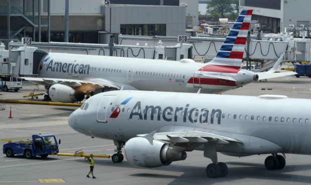 American Airlines passenger jets prepare for departure, Wednesday, July 21, 2021, near a terminal a...