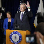 
              Massachusetts Gov. Charlie Baker, center, faces reporters as Mass. Attorney General Maura Healey, left, looks on during a news conference, in Boston, Thursday, July 8, 2021. In an agreement disclosed late Wednesday, July 7, in a filing in U.S. Bankruptcy Court, in White Plains, N.Y., more than a dozen states have dropped their objections to OxyContin maker Purdue Pharma's reorganization plan, edging the company closer to resolving its bankruptcy case. The new settlement terms call for Purdue to make tens of millions of internal documents public, a step several attorneys general, including Healey, had demanded as a way to hold the company accountable. (AP Photo/Steven Senne)
            