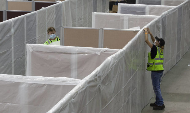 FILE — In this April 18, 2020 file photo sheeting is placed on partitions installed between beds ...