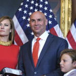 
              Rep. Jake Ellzey, R-Texas, joined by his wife Shelby, left, center, and their children, are seen after his wearing-in ceremony, at the Capitol in Washington, Friday, July 30, 2021. Ellzey won a special election in Texas's 6th congressional district which represents three counties just south of the Dallas-Fort Worth metropolitan region. (AP Photo/J. Scott Applewhite)
            