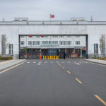 
              Police officers stand at the outer entrance of the Urumqi No. 3 Detention Center in Dabancheng in western China's Xinjiang Uyghur Autonomous Region on April 23, 2021. Urumqi No. 3, China's largest detention center, is twice the size of Vatican City and has room for at least 10,000 inmates. (AP Photo/Mark Schiefelbein)
            