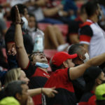 
              Brazil Flamengo fans cheer during a Copa Libertadores round of 16 second leg soccer match against Argentina's Defensa y Justicia, in the first game with fans after the COVID-19 pandemic, at the National Stadium in Brasilia, Brazil, Wednesday, July 21, 2021. (Adriano Machado/Pool via AP)
            