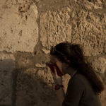 
              A woman prays at the Western Wall, the holiest site where Jews can pray, in the shadow of the Mughrabi Bridge, a wooden pedestrian bridge connecting the wall to the Al Aqsa Mosque compound, in Jerusalem's Old City, Tuesday, July 20, 2021. The rickety bridge allowing access to Jerusalem's most sensitive holy site is at risk of collapse, according to experts. But the flashpoint shrine's delicate position at ground-zero of the Israeli-Palestinian conflict has prevented its repair for more than a decade. (AP Photo/Maya Alleruzzo)
            