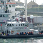 
              A group of people thought to be migrants are brought into port aboard a Border Force vessel, at Dover, England, Monday July 26, 2021.  The group of people were picked up by the border force vessel following a small boat incident in the Channel. (Gareth Fuller/PA via AP)
            