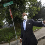 
              Tennessee State Rep. Harold Love, Jr. points toward interstate I-40 as he walks down his family's former street on the north side Monday, July, 19, 2021, in Nashville, Tenn. Love Jr.'s father, a Nashville city councilman, was forced to sell his family home here to make way for the highway, but put up a fight in the 1960s against the rerouting of Interstate 40 because he believed it would stifle and isolate Nashville's Black community. Love Jr. is now part of a group pushing to build a cap across the highway that creates a community space to help reunify the city. (AP Photo/John Amis)
            