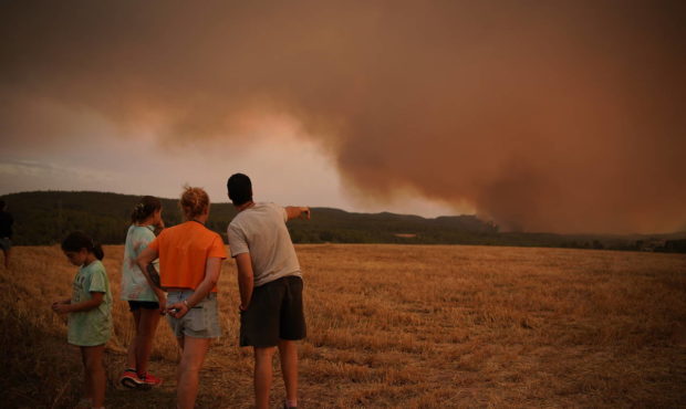 Residents look at wildfire near Tarragona, in the northeastern region of Catalonia, Spain, Sunday, ...