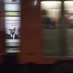 
              A subway going past frames an advertisement showing an image of Mexican former President Carlos Salinas, obscuring his eyes with a red bar, and calling for citizens to participate in a referendum on whether ex-presidents should be tried for their alleged crimes during their time in office, in Mexico City, Saturday, July 31, 2021. The yes-or-no referendum on Sunday is going to cost Mexico about $25 million, and the vote is being held in the middle of a third wave of the coronavirus pandemic. (AP Photo/Christian Palma)
            