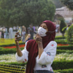 
              A woman takes selfie photos at the iconic Sultan Ahmed Mosque, better known as the Blue Mosque, in the historic Sultan Ahmed district of Istanbul, Tuesday, July 20, 2021. Thousands of Muslims attended dawn Eid al-Adha prayers at the the iconic Haghia Sophia and Blue Mosque in Istanbul. (AP Photo/Mucahid Yapici)
            