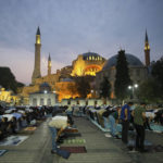 
              Muslims offer prayers during the first day of Eid al-Adha, outside the iconic Haghia Sophia in the historic Sultan Ahmed district of Istanbul, Tuesday, July 20, 2021. Thousands of Muslims attended dawn Eid al-Adha prayers in Istanbul. (AP Photo/Mucahid Yapici)
            