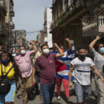 
              CORRECTS TO PRO-GOVERNMENT SUPPORTERS - Government supporters shout slogans as anti-government protesters march in Havana, Cuba, Sunday, July 11, 2021. Hundreds of demonstrators went out to the streets in several cities in Cuba to protest against ongoing food shortages and high prices of foodstuffs.  (AP Photo/Ismael Francisco)
            
