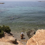 
              A woman reads a book at a beach of Kavouri suburb, southwest of Athens, on Friday, July 30, 2021. Greek authorities ordered additional fire patrols and infrastructure maintenance inspections Friday as the country grappled with a heat wave expected to last more than a week, with temperatures expected to reach 42 C (107.6 F). (AP Photo/Yorgos Karahalis)
            
