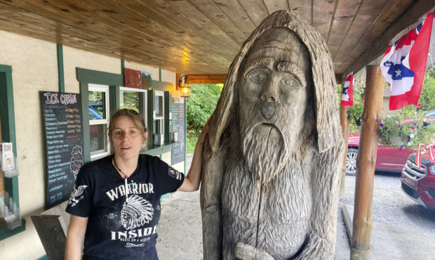 Pauline Bauer leans against a wooden statue outside Bob’s Trading Post, her restaurant in Hamilto...