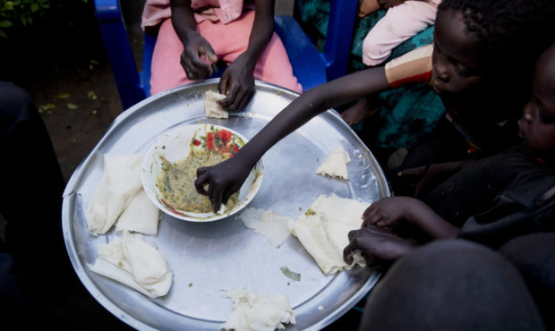 Paska Itwari Beda, the young mother of five children, shares a meal with her family at her Juba, So...