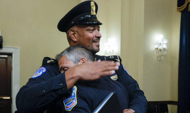 U.S. Capitol Police Sgt. Harry Dunn hugs Washington Metropolitan Police Department officer Michael ...