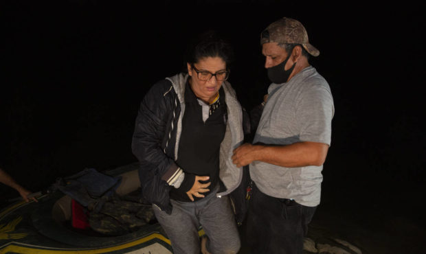 FILE - In this March 30, 2021, file photo Mayra Culio from Guatemala is helped off an inflatable ra...