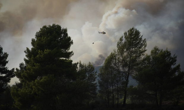 A wildfire in Santa Coloma de Queralt, near Tarragona, Spain, Sunday July 25, 2021. Firefighters in...