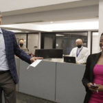 
              Grant Moise, left, The Dallas Morning News publisher, introduces Katrice Hardy as The News' executive editor, to the newsroom on Wednesday, July 21, 2021, in Dallas, Texas. Hardy, who also will be the first woman to hold the top job at the Dallas newsroom, will take up her duties next month. (Irwin Thompson/The Dallas Morning News via AP)
            