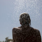 
              A woman takes a shower at a beach of Lagonissi village, a few miles southwest of Athens, on Thursday, July 29, 2021. One of the most severe heat waves recorded since 1980s scorched southeast Europe on Thursday, sending residents flocking to the coast, public fountains and air-conditioned locations to find some relief, with temperatures rose above 40 C (104 F) in parts of Greece and across much of the region. (AP Photo/Yorgos Karahalis)
            