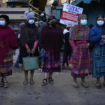 
              Women stand on the Inter American Highway as part of a crowd blocking it during a nationwide strike in Totonicapan, Guatemala, early Thursday, July 29, 2021. People are calling for the resignation of Guatemalan President Alejandro Giammattei and Attorney General Consuelo Porras after they fired Special Prosecutor Against Impunity Juan Francisco Sandoval. (AP Photo/Moises Castillo)
            