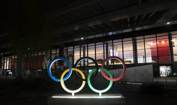 FILE - In this Saturday, July 10, 2021, file photo, the Olympic rings are illuminated outside the N...