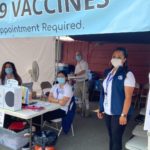 Bianca Ochoa, right, and her colleagues from Skagit County Public Health are giving vaccines at the fair through 10 p.m. Saturday. (Nicole Jennings/KIRO Radio)