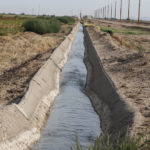 
              Colorado River water flows through a canal that feeds farms operated by Tempe Farming Co., in Casa Grande, Ariz., Thursday, July 22, 2021. The Colorado River has been a go-to source of water for cities, tribes and farmers in the U.S. West for decades. But climate change, drought and increased demand are taking a toll. The U.S. Bureau of Reclamation is expected to declare the first-ever mandatory cuts from the river for 2022. (AP Photo/Darryl Webb)
            
