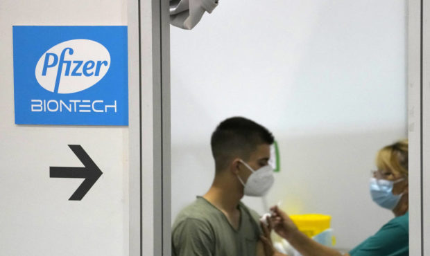 A medical worker administers a shot of Pfizer COVID-19 vaccine to a man at Belgrade Fair makeshift ...