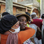 
              People cry during the search for those who are still missing in a house destroyed by the earthquake in Les Cayes, Haiti, Sunday, Aug. 15, 2021. The death toll from a magnitude 7.2 earthquake in Haiti climbed to more than 1,200 on Sunday as rescuers raced to find survivors amid the rubble ahead an approaching tropical storm. (AP Photo/Joseph Odelyn)
            