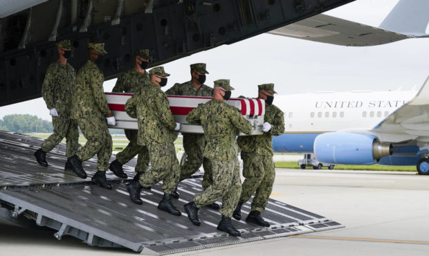 US Military servicemen carrying the casket of a fallen soldier killed in the bombings outside the K...