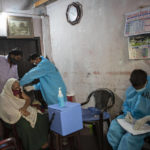 
              Sri Lankan army's medical corps members administer a vaccine for COVID-19 to an elderly Muslim woman at her house in Colombo, Sri Lanka, Saturday, Aug. 14, 2021. (AP Photo/Eranga Jayawardena)
            