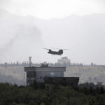 
              A U.S. Chinook helicopter flies over the U.S. Embassy in Kabul, Afghanistan, Sunday, Aug. 15, 2021. Helicopters are landing at the U.S. Embassy in Kabul as diplomatic vehicles leave the compound amid the Taliban advanced on the Afghan capital. (AP Photo/Rahmat Gul)
            