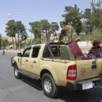 
              Taliban fighters sit on the back of a vehicle in the city of Herat, west of Kabul, Afghanistan, Saturday, Aug. 14, 2021, after they took this province from Afghan government. The Taliban seized two more provinces and approached the outskirts of Afghanistan’s capital. (AP Photo/Hamed Sarfarazi)
            