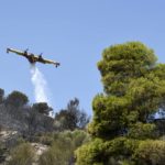 
              An aircraft drops water in Lampiri village, east of Patras city, Greece, Sunday, Aug. 1, 2021. A wildfire that broke out Saturday in western Greece forced the evacuation of four villages and people on a beach by the Fire Service, the Coast Guard and private boats, authorities said. (AP Photo/Andreas Alexopoulos)
            