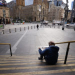 
              A man reads a newspaper on the steps of Flinders Street Station in Melbourne, Australia, Wednesday, Aug. 11, 2021. Australia's second-largest city has extended its lockdown in a bid to eliminate COVID-19 while authorities in Sydney flagged restrictions easing for vaccinated residents despite the delta variant continuing to spread. (AAP Image/Daniel Pockett)
            