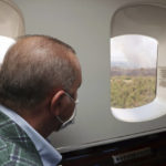 
              Turkey's President Recep Tayyip Erdogan watches from his plane the wildfires in Manavgat, Antalya, Turkey, Saturday, July 31, 2021. The death toll from wildfires raging in Turkey's Mediterranean towns rose to six Saturday after two forest workers were killed, the country's health minister said. Fires across Turkey since Wednesday burned down forests, encroaching on villages and tourist destinations and forcing people to evacuate.(Turkish Presidency via AP, Pool)
            
