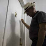 
              Gary Zaremba knocks on an apartment door as he checks in with tenants to discuss building maintenance at one of his at properties, Thursday, Aug. 12, 2021, in the Queens borough of New York. Landlords say they have suffered financially due to various state, local and federal moratoriums in place since last year. “Without rent, we’re out of business," said Zaremba. (AP Photo/John Minchillo)
            