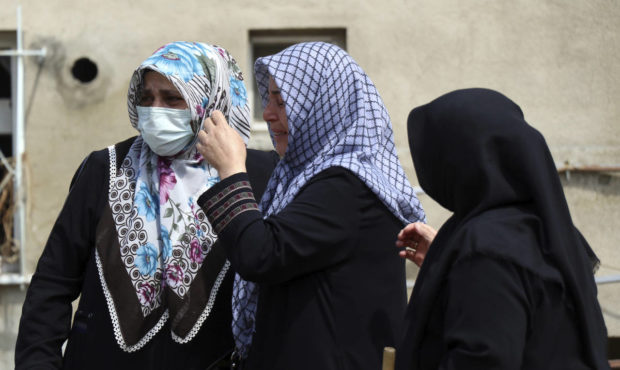 Women react as they look at the destroyed building where they lived, in Bozkurt town of Kastamonu p...