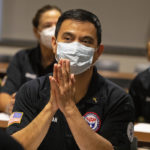 
              After his hands were blessed by a priest, Matthew Tran, a pharmacist prays with nearly three dozen other healthcare workers from around the country who arrived to help supplement the staff at Our Lady of the Lake Regional Medical Center in Baton Rouge, La., Monday, Aug. 2, 2021.  Louisiana has one of the lowest coronavirus vaccination rates in the nation and is seeing one of the country’s worst COVID-19 spikes.  (AP Photo/Ted Jackson)
            