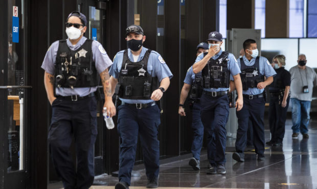 Chicago police officers walk into the Leighton Criminal Courthouse to attend the bond hearing for E...