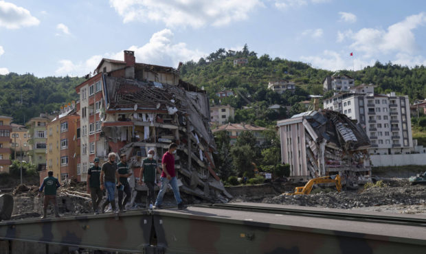 People walk on a temporary bridge set up by military in Bozkurt town of Kastamonu province, Turkey,...