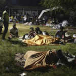 
              People displaced from their earthquake destroyed homes spend the night outdoors in a grassy area that is part of a hospital in Les Cayes, Haiti, late Saturday, Aug. 14, 2021. A powerful magnitude 7.2 earthquake struck southwestern Haiti on Saturday. (AP Photo/Joseph Odelyn)
            