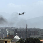 
              A U.S. Chinook helicopter flies over the city of Kabul, Afghanistan, Sunday, Aug. 15, 2021. Taliban fighters entered the outskirts of the Afghan capital on Sunday, further tightening their grip on the country as panicked workers fled government offices and helicopters landed at the U.S. Embassy. (AP Photo/Rahmat Gul)
            