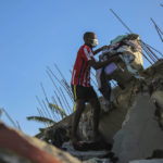 
              A man recovers belongings from his home that was destroyed by the earthquake in Les Cayes, Haiti, Saturday, Aug. 14, 2021. A 7.2 magnitude earthquake struck Haiti on Saturday, with the epicenter about 125 kilometers (78 miles) west of the capital of Port-au-Prince, the US Geological Survey said. (AP Photo/Joseph Odelyn)
            