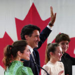 
              Prime Minister Justin Trudeau is joined on stage by wife Sophie Gregoire Trudeau, left, and children Xavier and Ella-Grace, during his victory speech at Party campaign headquarters in Montreal, early Tuesday, Sept. 21, 2021.  (Sean Kilpatrick/The Canadian Press via AP)
            